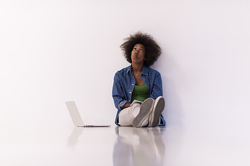 Image showing african american woman sitting on floor with laptop