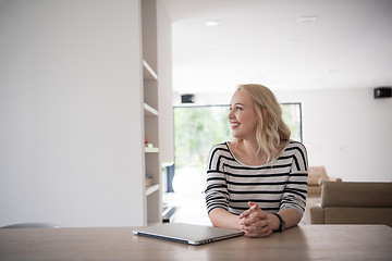 Image showing Young woman with laptop at home