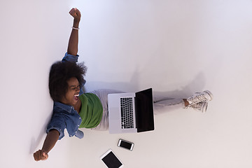 Image showing african american woman sitting on floor with laptop top view