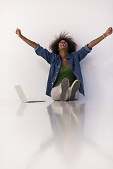 Image showing african american woman sitting on floor with laptop