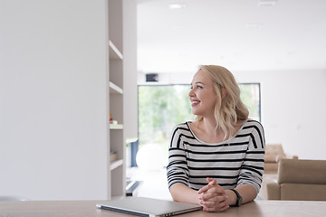 Image showing Young woman with laptop at home