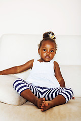 Image showing little pretty african american girl sitting in white chair weari