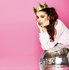 Image showing young cute disco girl on pink background with disco ball and cro