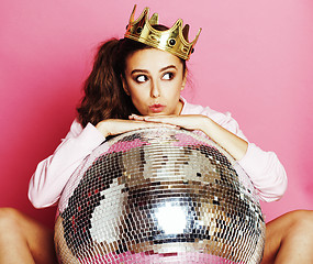 Image showing young cute disco girl on pink background with disco ball and cro