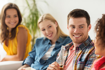 Image showing group of happy friends with beer talking at home