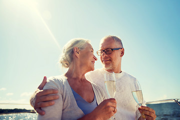 Image showing senior couple drinking champagne on sail boat