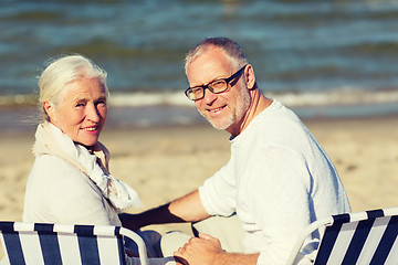 Image showing senior couple sitting on chairs at summer beach