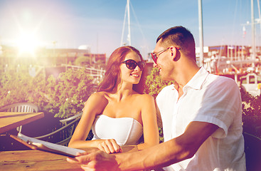 Image showing smiling couple with menu at cafe