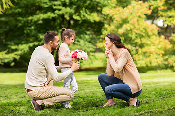 Image showing happy family with flowers in summer park