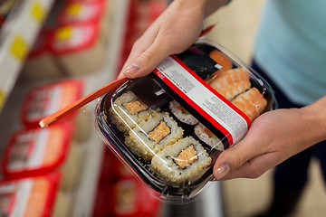 Image showing hands with sushi pack at grocery or supermarket