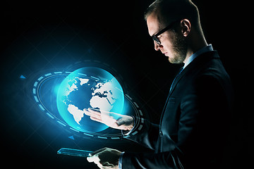 Image showing businessman with tablet pc and earth hologram