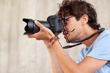 Image showing close up of  photographer with camera shooting