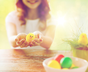 Image showing close up of girl holding yellow chicken toy