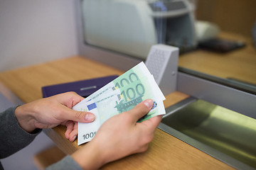 Image showing hands with money at bank or currency exchanger