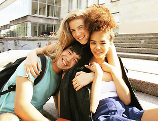 Image showing cute group of teenages at the building of university with books 