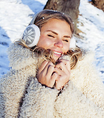 Image showing young pretty teenage hipster girl outdoor in winter snow park having fun drinking coffee, warming up happy smiling, lifestyle people concept