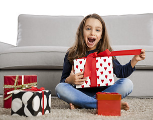 Image showing Little girl opening presents