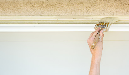 Image showing Professional Painter Cutting In With Brush to Paint Garage Door 