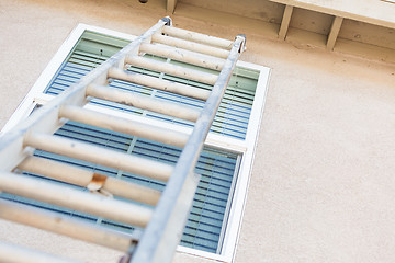 Image showing Construction Ladder Leaning Against House