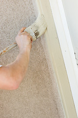 Image showing Professional Painter Cutting In With Brush to Paint Garage Door 