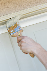 Image showing Professional Painter Cutting In With Brush to Paint Garage Door 