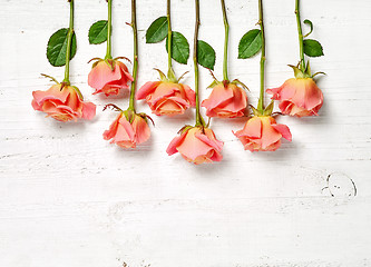 Image showing pink roses on white wooden table