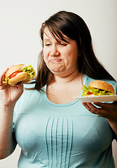 Image showing fat white woman having choice between hamburger and salad close 