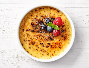 Image showing bowl of creme brule on white wooden table