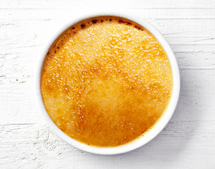 Image showing bowl of creme brule on white wooden table