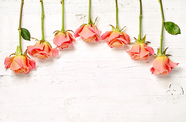 Image showing pink roses on white wooden table