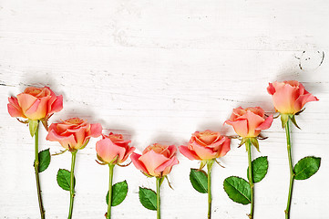 Image showing pink roses on white wooden table