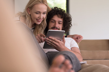 Image showing couple relaxing at  home with tablet computers