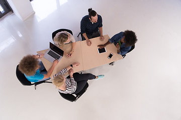 Image showing Multiethnic startup business team on meeting  top view