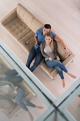 Image showing youg couple in living room with tablet top view