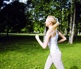 Image showing young pretty blond woman doing sport in park in sunny day at summer, lifestyle people concept