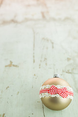 Image showing Three Christmas baubles on rustic wood