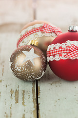 Image showing Three Christmas baubles on rustic wood