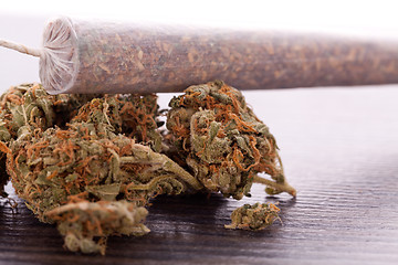 Image showing Close up of dried marijuana leaves and joint