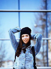 Image showing young pretty girl near business building walking