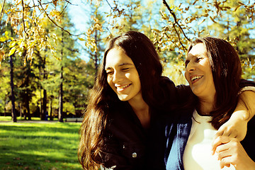 Image showing mature real mother with daughter outside autumn fall in park