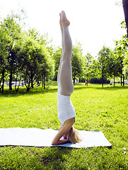 Image showing blonde real girl doing yoga in green park, lifestyle people concept close up