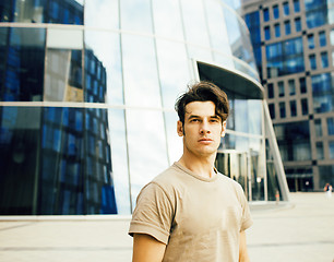 Image showing young handsome modern guy posing infront of business building, lifestyle people concept
