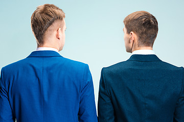 Image showing Two young stylish men in a suit. Rear view from the back.