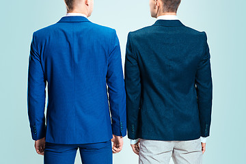 Image showing Two young stylish men in a suit. Rear view from the back.