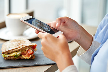 Image showing hands with smartphone photographing food