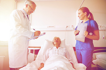 Image showing doctor and nurse visiting senior woman at hospital