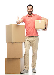 Image showing happy man with cardboard boxes showing thumbs up