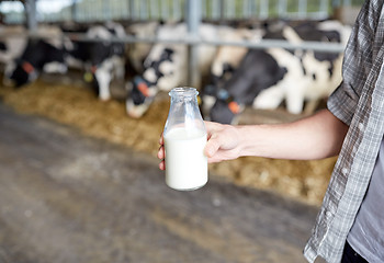 Image showing close up of man or farmer with milk on dairy farm