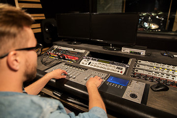 Image showing man at mixing console in music recording studio