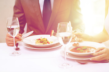 Image showing close up of couple eating appetizers at restaurant